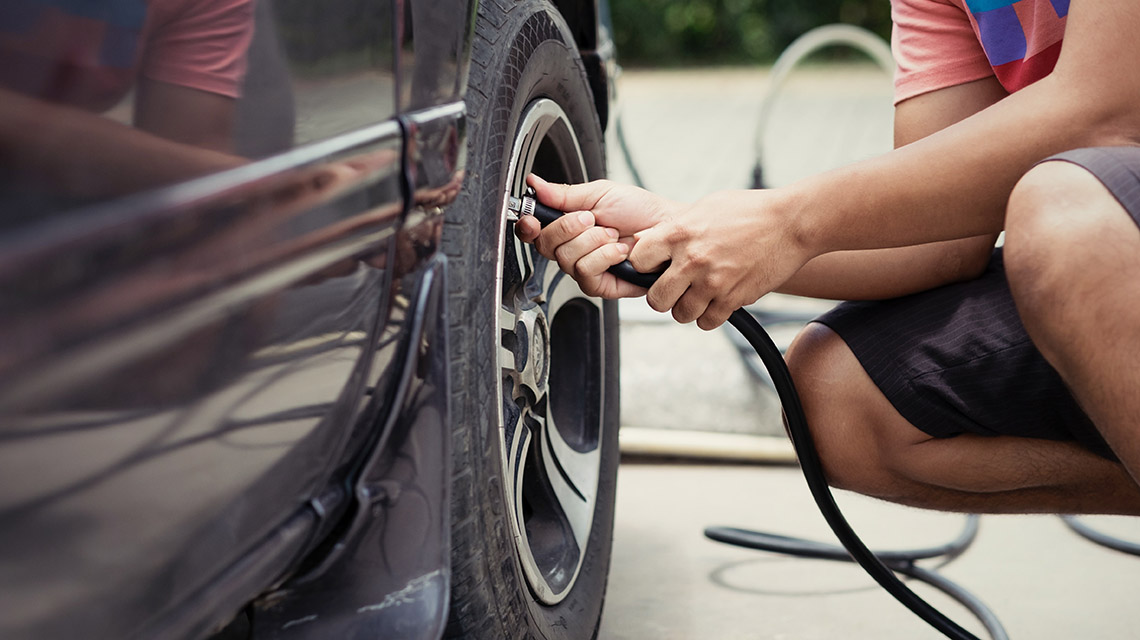 Man pumping car tyre up