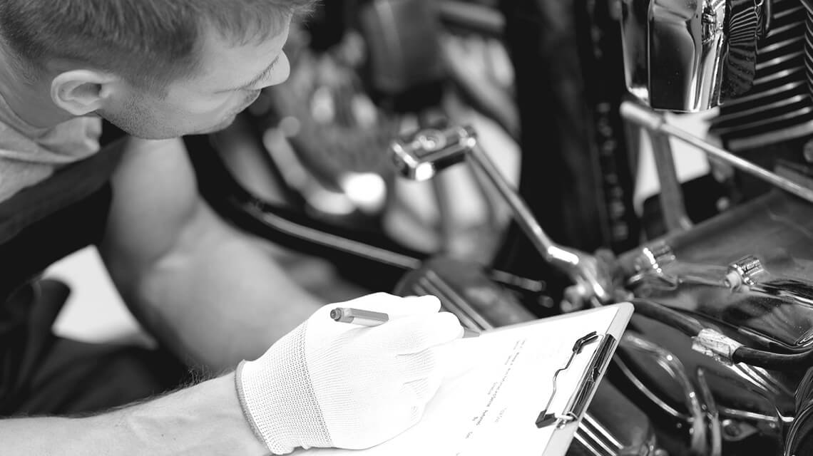 man checking over motorbike